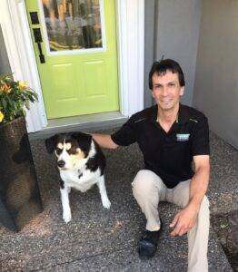 Professional Carpet Cleaner from Amazing Results, Jamie, sitting on a front doorstep ready to service your carpets.